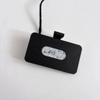 Black rectangular LED light fixture with a textured finish and integrated power cord.
