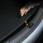 Black heavy-duty fabric trunk mat being easily installed into a car boot using a convenient strap.