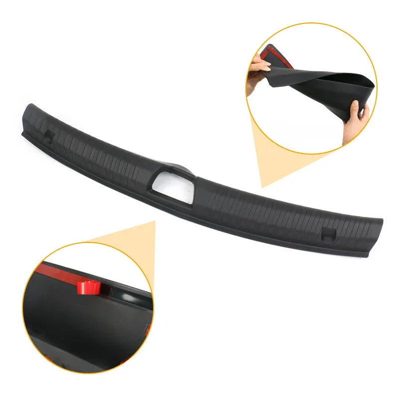 Flexible black rubber trunk mat with red edge trim for durable car cargo protection.