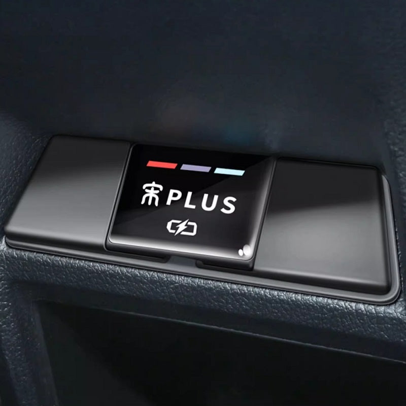 Black glossy plastic interior button panel with white PLUS text and indicator lights