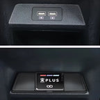 Black textured interior console featuring dual USB charging ports and a sleek PLUS control button.