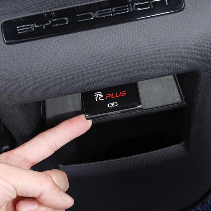 Close-up of a black matte BYD Han Plus door storage cover with red lettering.