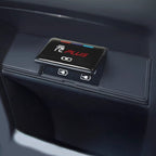 Close-up of a black glossy PLUS wireless charger for BYD car interiors with battery icons.