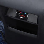 Close-up of black plastic car interior panel with a backlit red and blue PLUS temperature control button.