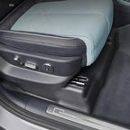 Light blue textured leather car seat with black trim and premium stitching.