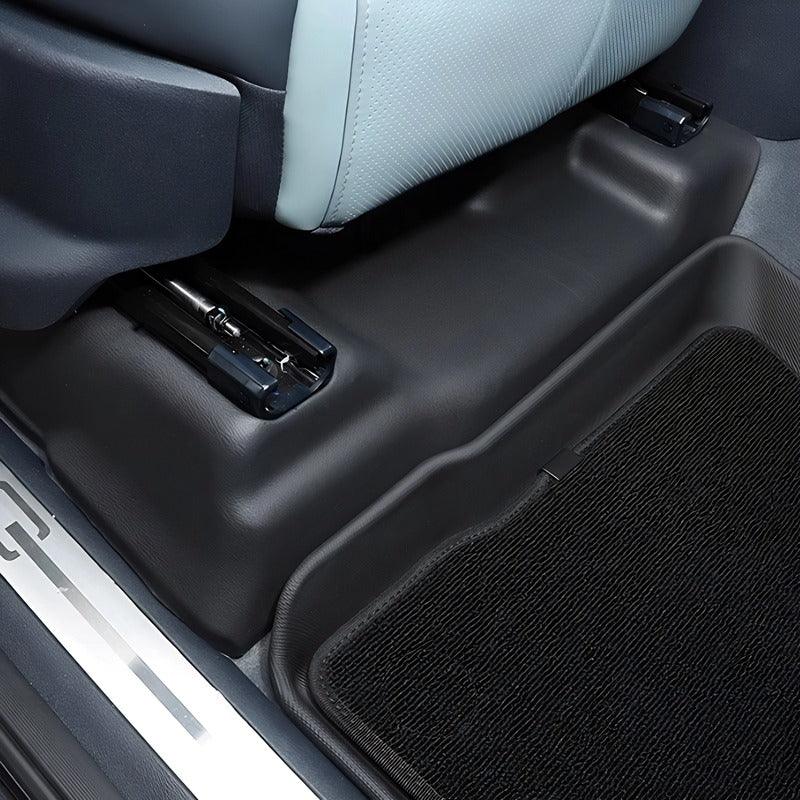 Black textured car floor mat and protective trim for BYD vehicle interior.