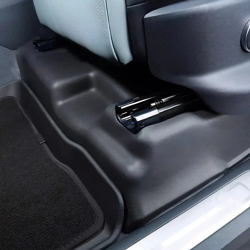 Black heavy-duty TPE floor mats and protective side trim for car interior durability.