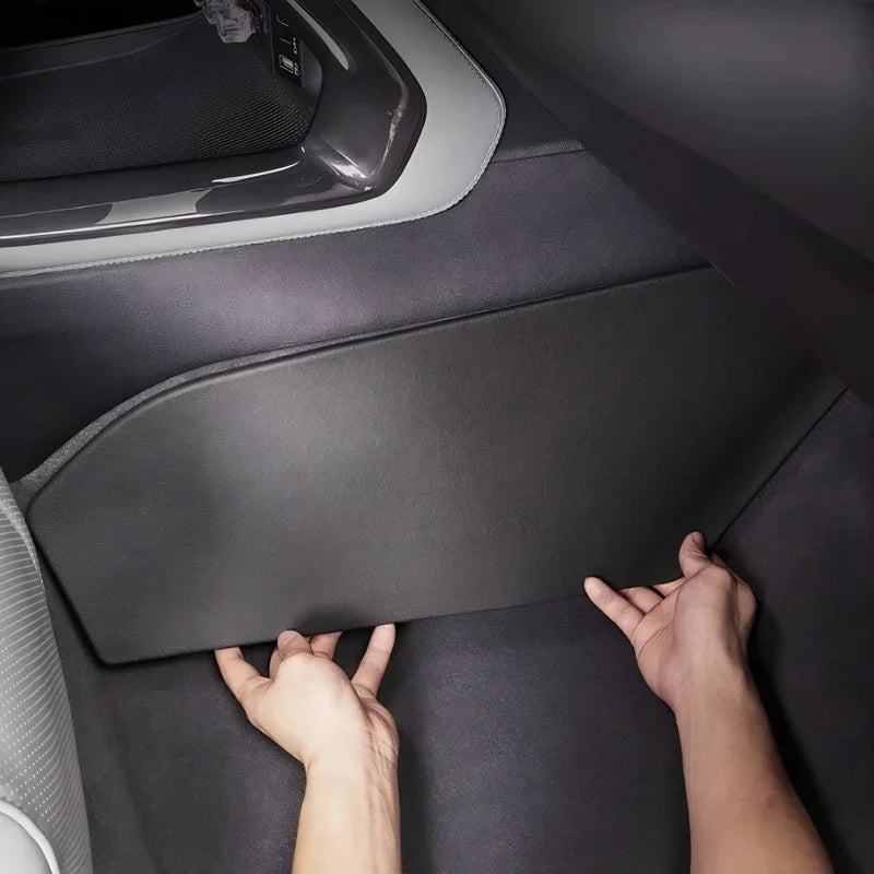 Black premium leatherette kick mat protector being installed on car interior side panel.