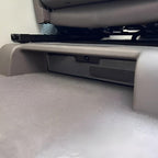 Gray protective car floor mat under a vehicle seat, providing durable coverage.