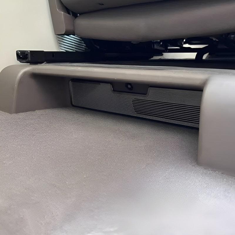 Gray protective car floor mat under a vehicle seat, providing durable coverage.