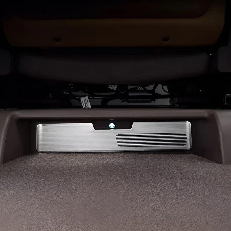 Silver brushed aluminum car interior kick plate with ribbed detail and integrated light.