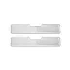 Pair of sleek silver metallic door sill protectors with a ribbed texture design.
