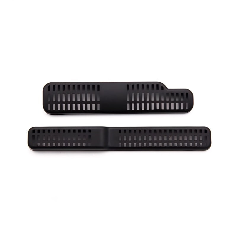 Two matte black plastic slotted ventilation grilles for automotive interior accessories.