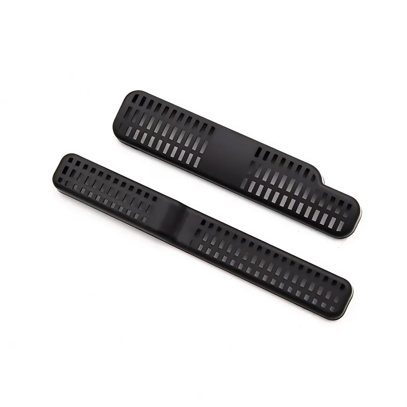 Pair of durable matte black plastic car pedal covers with anti-slip ribbed texture.