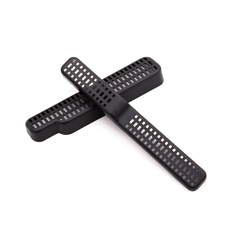 Black perforated plastic vent covers for automotive interior protection.