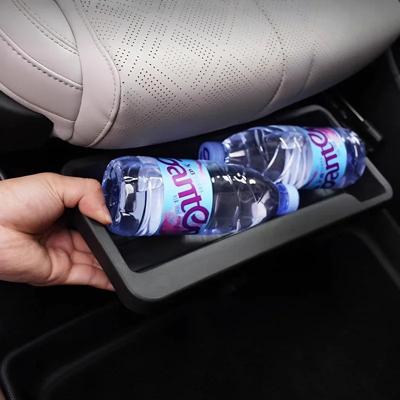 Matte black plastic car seat back organizer holding two water bottles