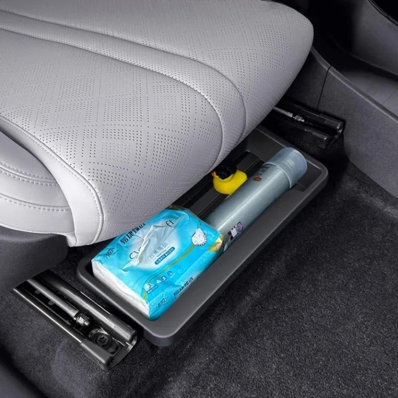 Grey durable plastic under-seat storage organizer for car interiors holding essentials.