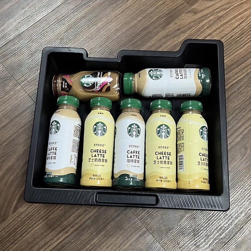 Six Starbucks bottled coffee drinks, including Caffe Latte and Cheese Latte, in a black plastic tray.