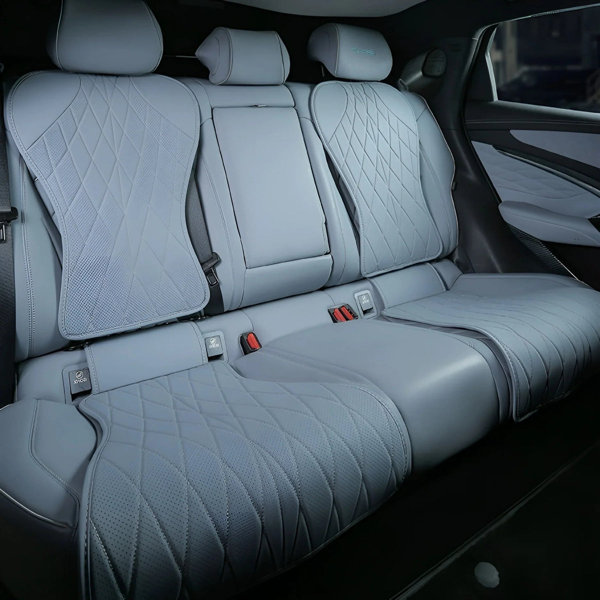 Light grey diamond-quilted leather car seat covers for rear passenger seats.