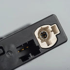 Close-up of a professional black plastic car accessory connector with a white inner socket.