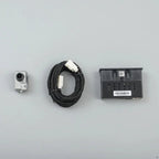 Silver metal backup camera with a black braided cable and black plastic mounting bracket.