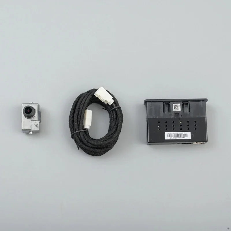 Silver metal backup camera with a black braided cable and black plastic mounting bracket.