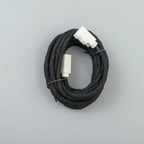 Coiled black fabric-wrapped automotive wiring harness with white plastic connectors
