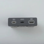 Dark grey electronic device featuring USB-C and USB-A ports with a central switch.