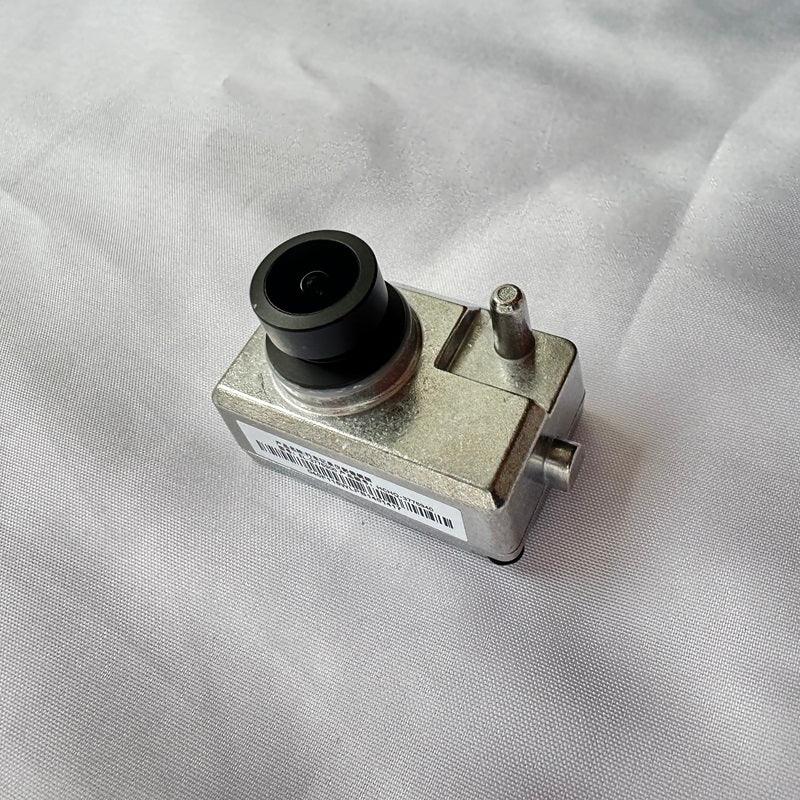 Durable silver metallic automotive sensor component with a black circular housing.