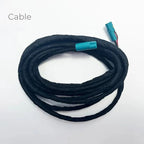 Coiled black fabric-wrapped electrical cable with teal blue connectors