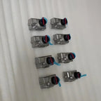 Set of 8 silver metallic automotive valves with blue protective caps and red ring accents.
