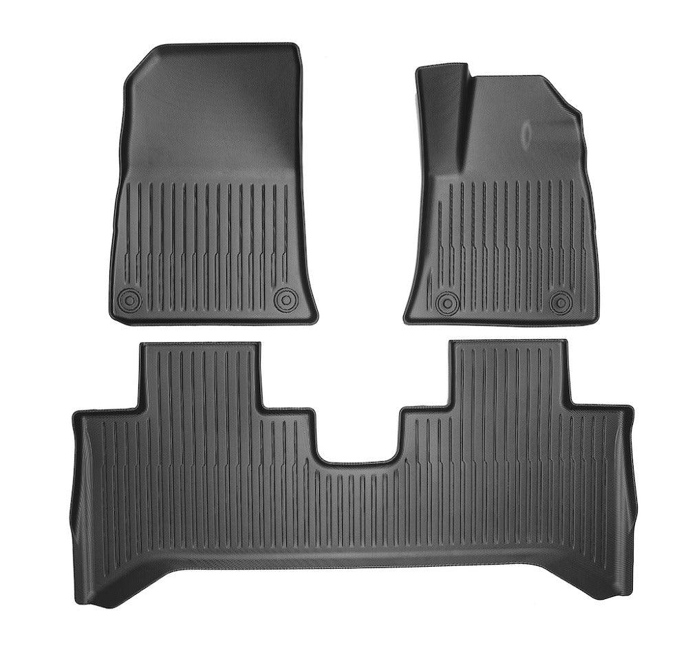 Black heavy-duty rubber car floor mats set with anti-slip ribbed texture for complete protection.