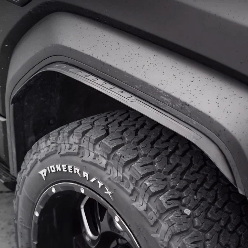 Black matte textured fender flare installed over a rugged all-terrain tire.
