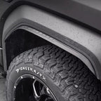 Black matte textured fender flare installed over a rugged all-terrain tire.