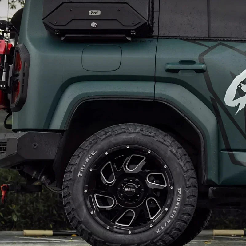 Rugged matte green off-road tire with black and silver alloy rim for BYD accessories.