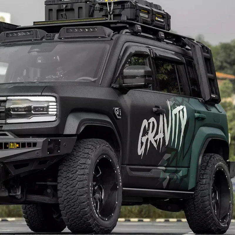 Matte black and dark green rugged off-road SUV featuring heavy-duty roof racks and all-terrain tires.