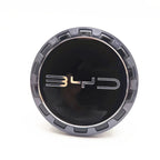 Glossy black BYD emblem center cap with metallic silver rim for car wheel protection.