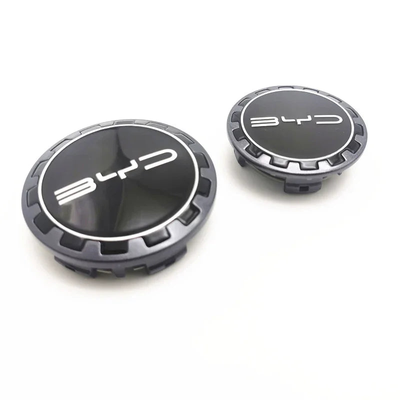 Two black and silver BYD logo valve stem caps with a sleek metallic finish.