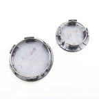 Grey plastic circular replacement cap with integrated metal retaining clips.