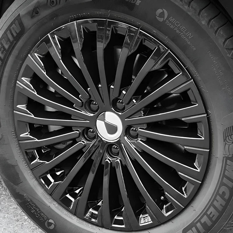 Close-up of a glossy black multi-spoke alloy car wheel with a Michelin tire.