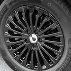Close-up of a glossy black multi-spoke alloy car wheel with a Michelin tire.