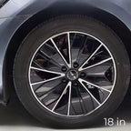 18-inch black and silver dual-tone alloy car wheel rim with a multi-spoke geometric design.