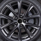 Close-up of a sleek black multi-spoke alloy car wheel with a metallic finish.