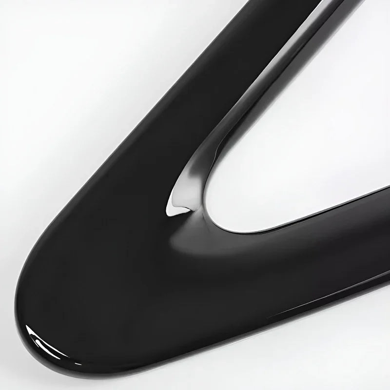 Smooth, glossy black liquid texture with a thick, viscous consistency and reflective surface.