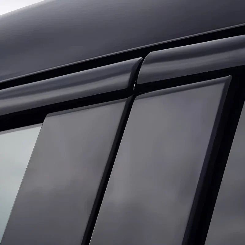 Black sleek window deflectors installed on a car for aerodynamic protection.