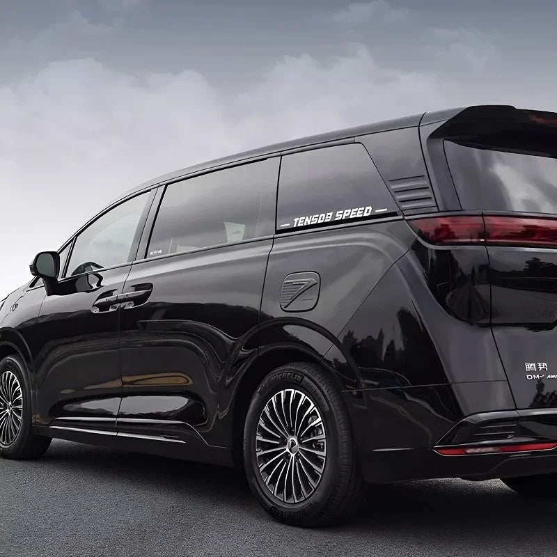 Side view of a black BYD MPV with custom multi-spoke silver alloy wheels and tinted windows.