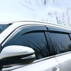 Sleek dark tinted window deflectors installed on a white BYD vehicle side window.