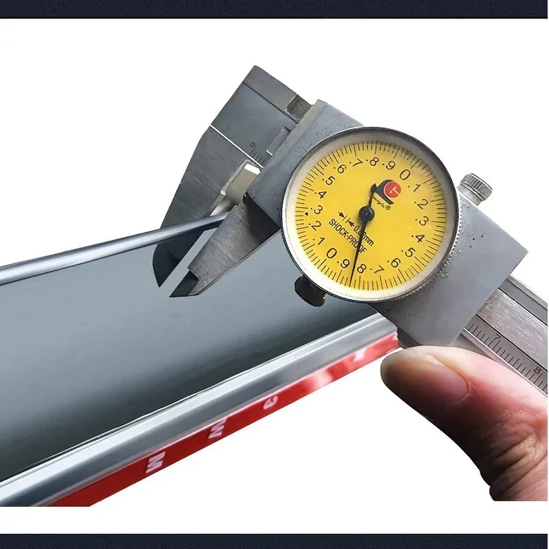 Precision metal vernier caliper measuring the thickness of a car window glass.