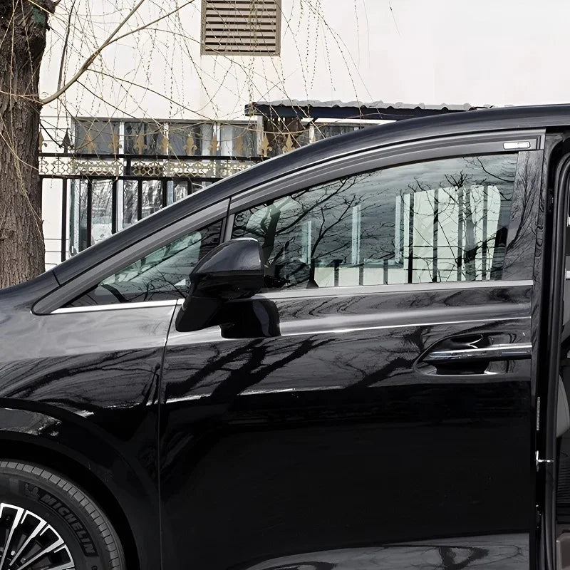 Black acrylic rain guards installed on the side windows of a black car
