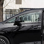 Black acrylic rain guards installed on the side windows of a black car
